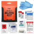 Burn kit with various burn care supplies including a glove, dressings, and wipes on a white background.